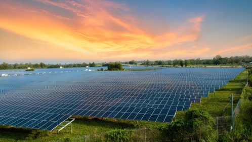 Solar panels (solar cell) in solar farm with blue sky