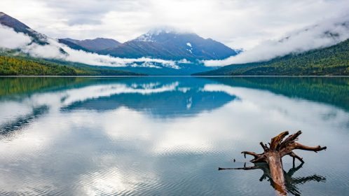 Alaska northern lake with snow mountains in the back
