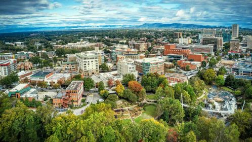 Aerial panoramic view of downtown Greenville, SC buildings under cloudy sky