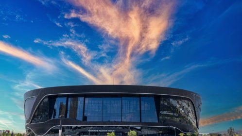 A gorgeous spring landscape at Allegiant Stadium surrounded by lush green trees and plants and a gorgeous blue sky with clouds in Las Vegas Nevada USA